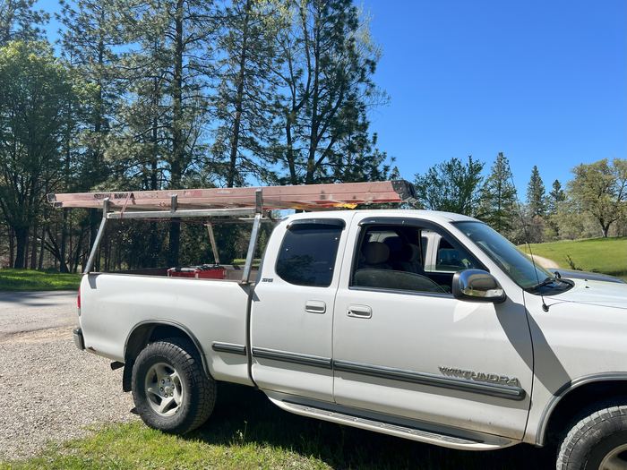 Truck lumber rack carrying a load of ladders