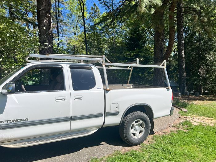 Lumber rack on a white pickup truck, seen from the side