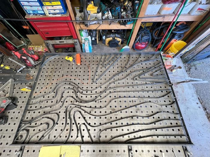 A Topograin railing panel laid out on the welding table