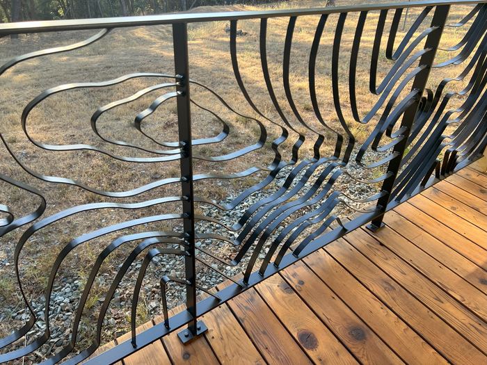 Close view of the Topograin contour lines where they meet a railing post